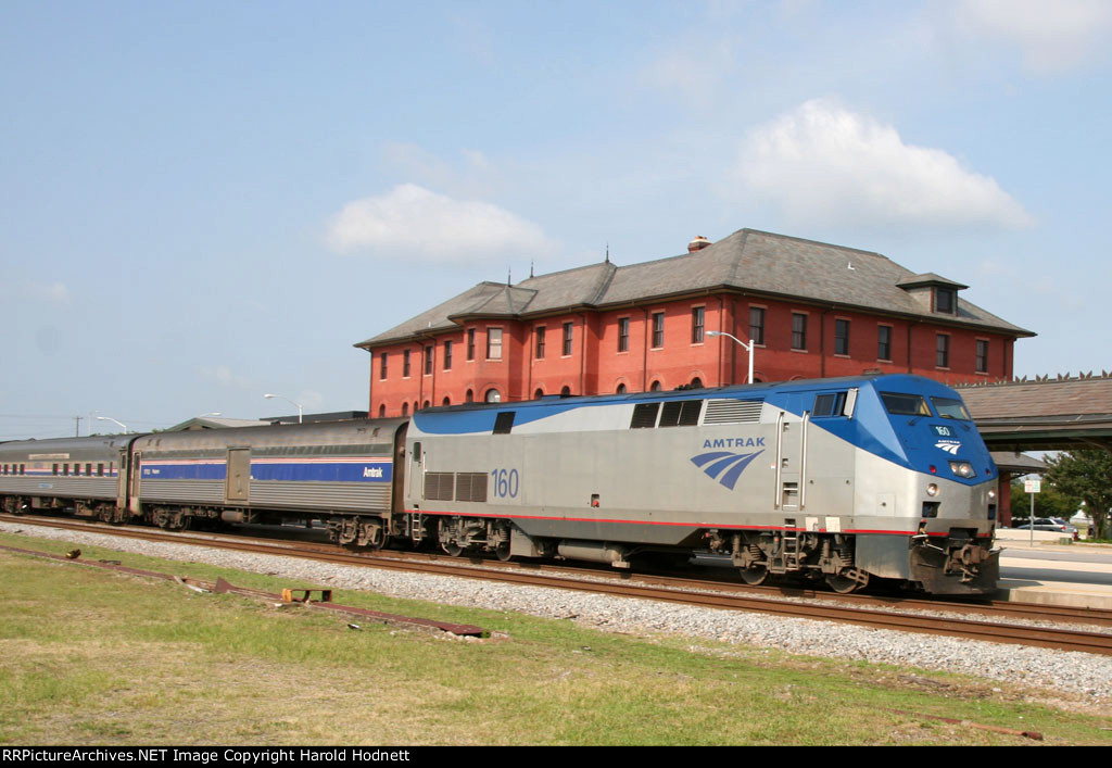 AMTK 160 leads train P080 into the station